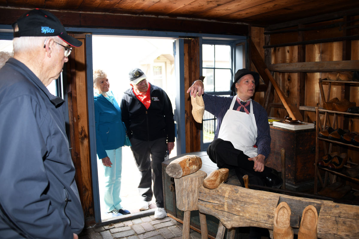 172 Arvid Janzen and Sylvia and Leo Epp watch the process of making wooden shoes.JPG